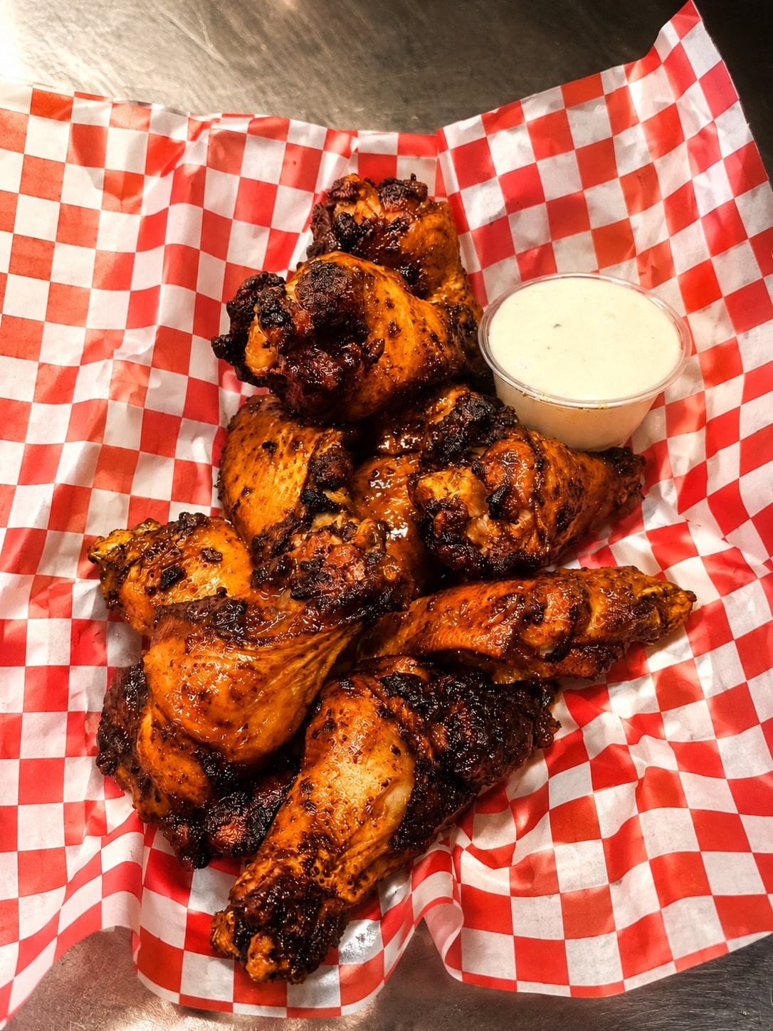 Charred chicken wings with ranch dipping sauce
